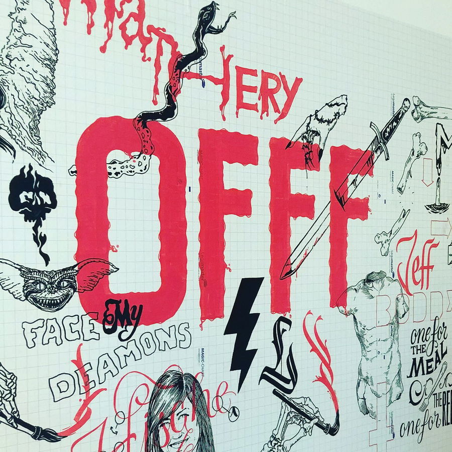 Hand-drawn mural with large red letters spelling OFFF, surrounded by black and red illustrations, text, and sketches including snakes, faces, arrows, and phrases like face my demons and one for the meat.