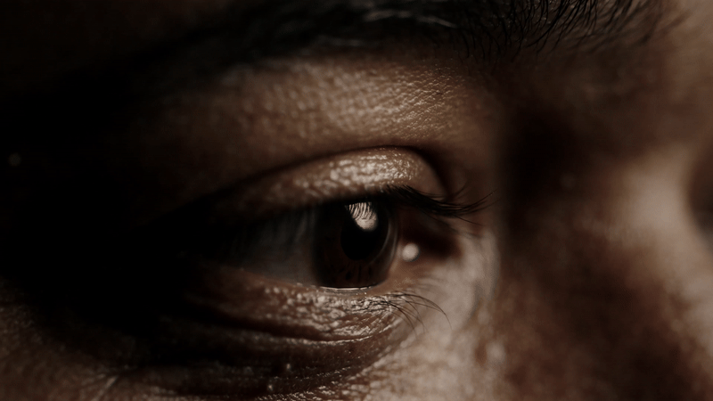 Close-up of a person’s eye, showing detailed skin texture, eyelashes, and reflections in the eye. The lighting highlights the contours around the eye, emphasising emotion and focus—perfect for visuals supporting the #NotTheOne campaign.