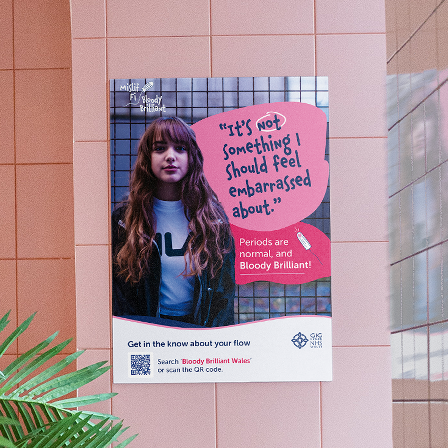 A poster featuring a young woman with long hair and a serious expression. Text reads, It’s not something I should feel embarrassed about. Periods are normal, and Bloody Brilliant! Powered by Brandbag. There’s a QR code at the bottom.