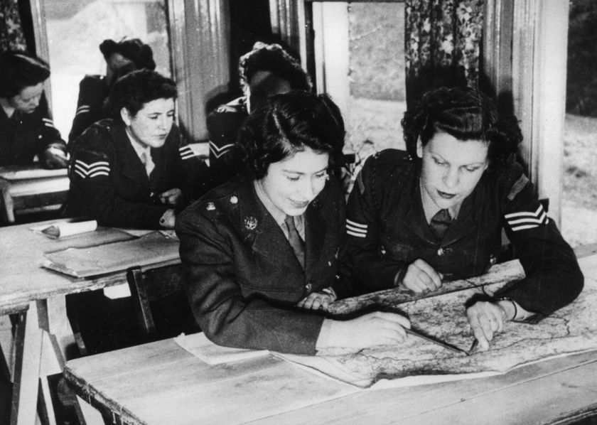 A group of women in military uniforms study a map together at a classroom table, their teamwork reflecting the spirit of The Queen’s Platinum Jubilee. Two women in the foreground are focused on the map, whilst others work in the background.