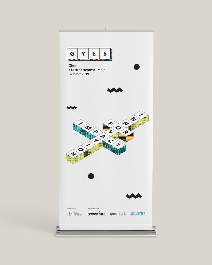 A standing banner for the Global Youth Entrepreneurship Summit 2019 features the event name and a crossword design with words like Impact, Innovate, and Foster, along with sponsor logos at the bottom.