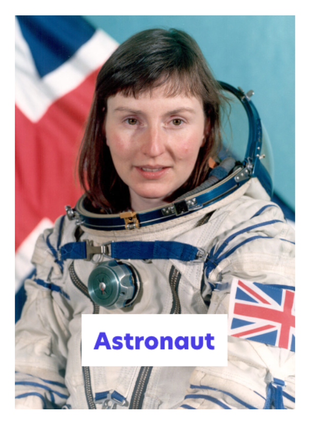 A woman in a spacesuit with a Union Jack patch on the sleeve sits in front of a Union Jack flag. The caption “Astronaut” is written at the bottom of the image.