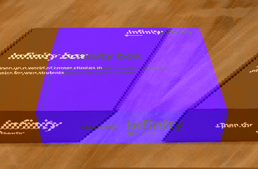 A purple box labelled Infinity box with the text Open up a world of career choices in physics for your students. The front reads Open for Infinity with the Future First logo, all on a wooden surface.