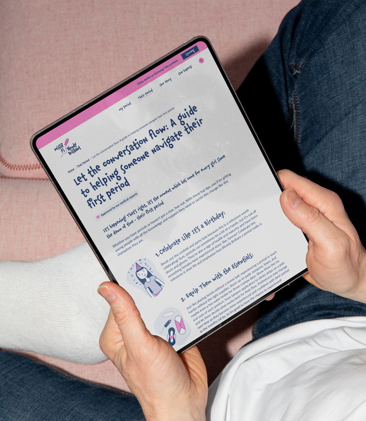 A person holds a tablet displaying a website about finding free period products. The screen shows cartoon illustrations, search options, and a headline reading “Find Free Period Products Near You” on a pink and blue background.