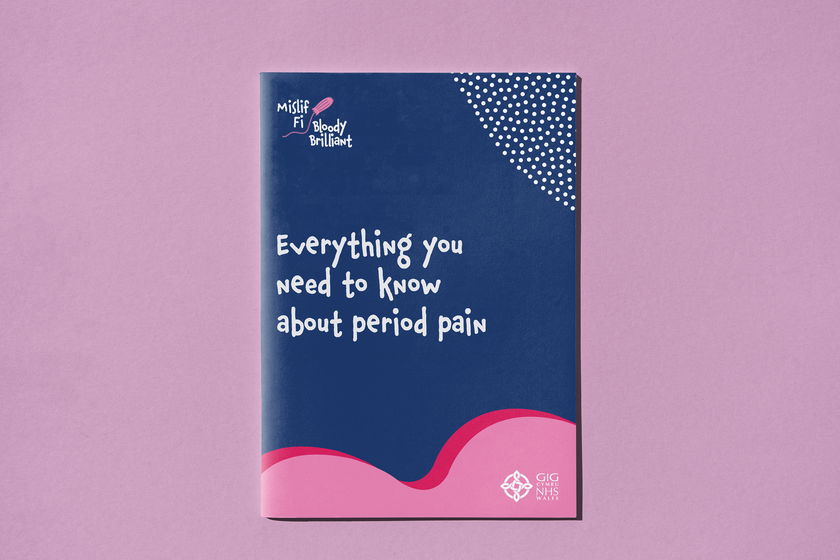 A booklet with a dark blue and pink cover titled Everything you need to know about period pain, featuring the Gig NHS Wales logo and abstract dotted and wave patterns, placed on a pink background.