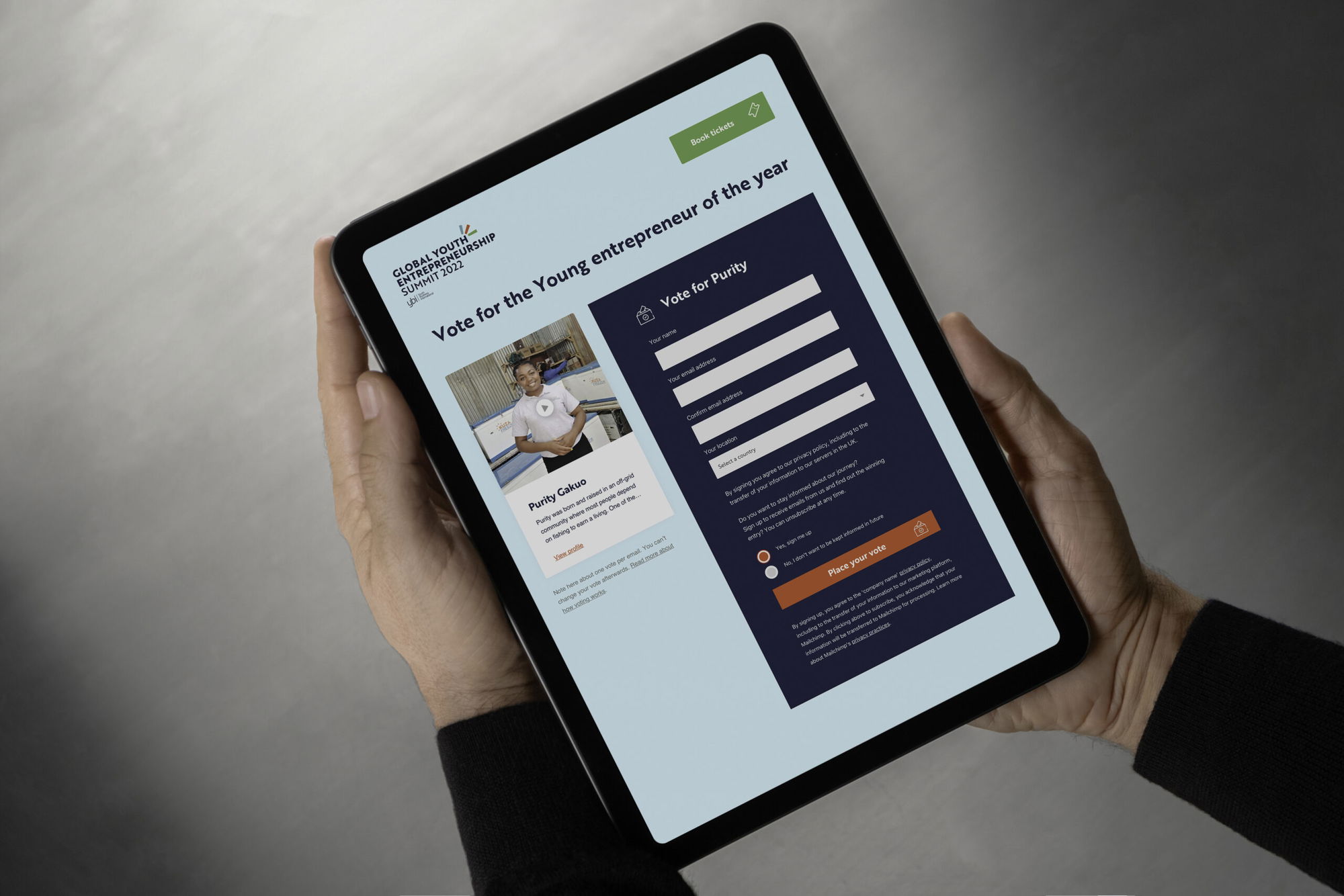 A person holds a tablet displaying a voting page for Young Entrepreneur of the Year, featuring a nominee’s photo, name, and a form to submit a vote. The screen also shows the Submit your vote button.