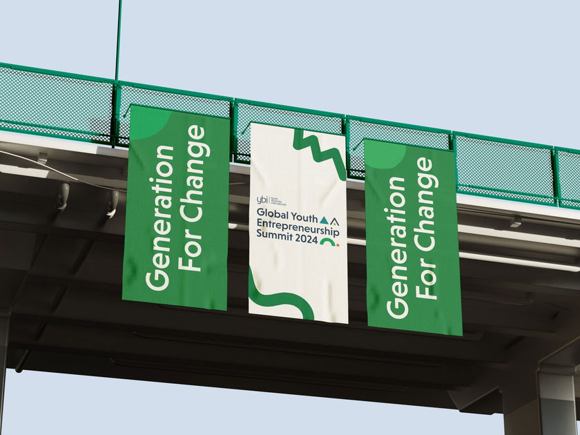 Three vertical banners hang from a bridge. The outer two are green with “Generation For Change” in white text. The centre banner promotes the “Global Youth Entrepreneurship Summit 2024” with abstract graphics.